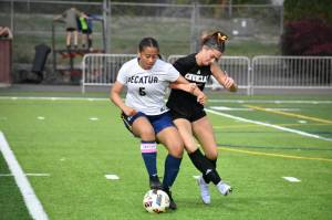 Madison Holden fights for the ball against a Decatur player. Ben Ray / The Herald