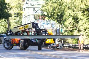 Guy F. Atkinson Construction workers moving a steel beam manufactured by Farwest Fabrication, owned by Enumclaw local Brie Crites. Photo by Ray Miller-Still
