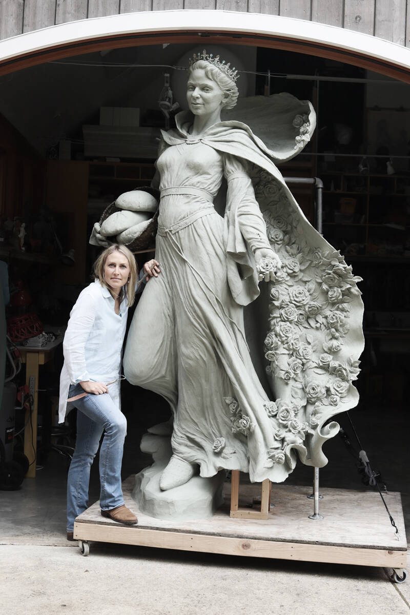 Artist Mardie Rees with her statue of the Miracle of Roses. Submitted photo