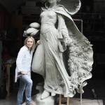 Artist Mardie Rees with her statue of the Miracle of Roses. Submitted photo
