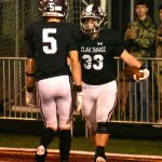 Hornet running back Maddox Hendrickson (33) celebrates a touchdown with teammate Kolt Kuzaro.