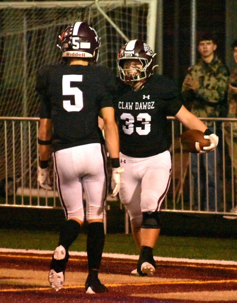 Hornet running back Maddox Hendrickson (33) celebrates a touchdown with teammate Kolt Kuzaro.