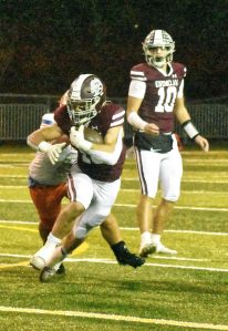 PHOTO BY KEVIN HANSON Running back Paxton Patterson gains some tough yardage after taking a handoff from quarterback Gavin Trachte (10).