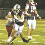 PHOTO BY KEVIN HANSON Running back Paxton Patterson gains some tough yardage after taking a handoff from quarterback Gavin Trachte (10).