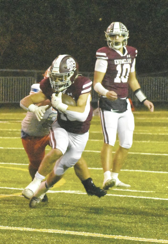 PHOTO BY KEVIN HANSON Running back Paxton Patterson gains some tough yardage after taking a handoff from quarterback Gavin Trachte (10).