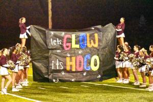 PHOTO BY KEVIN HANSON The Enumclaw cheer squad at the Hornet homecoming game, seconds before the team bursted through the sign.