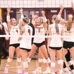 PHOTO BY KEVIN HANSON White River volleyball players (and coach Hayley Steinman, left) celebrate their Thursday night victory over Enumclaw High.