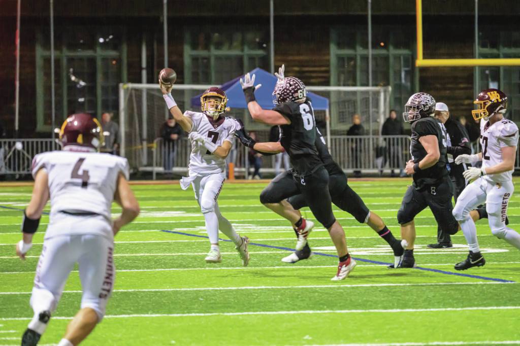WRHS Chaz Strickland (No. 7) attempts to pass to Blake Bargelt (4). Photo by Vic Wright
