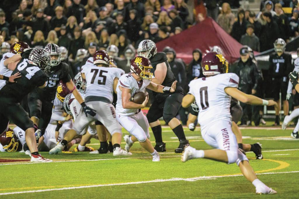 White River's Kovi Poulin does his best to navigate Enumclaw's defense. Photo by Vic Wright