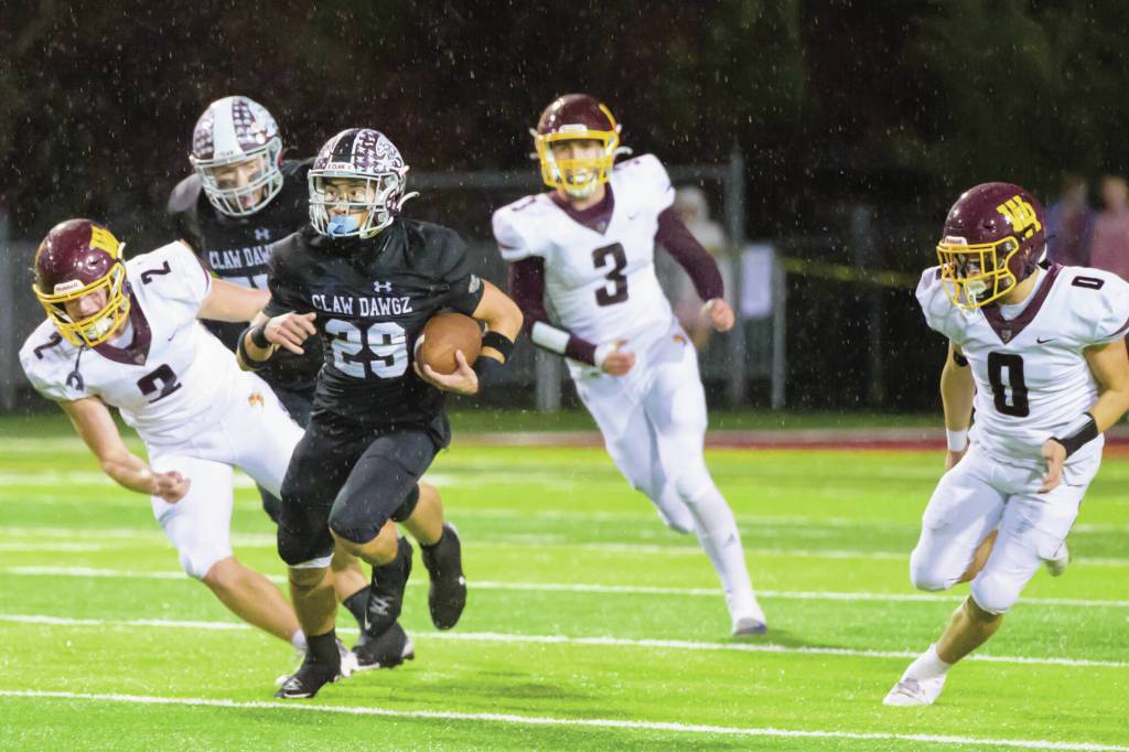 Enumclaw senior Cole Chiechi gaining some yardage before being taken down by White River. Photo by Vic Wright