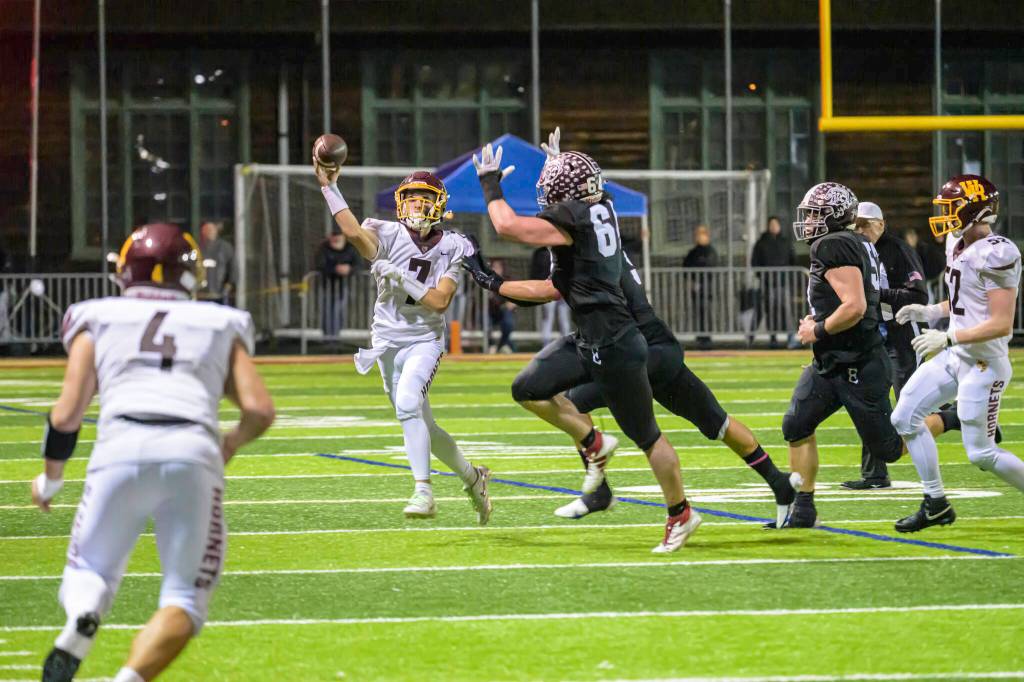 WRHS Chaz Strickland (No. 7) attempts to pass to Blake Bargelt (4). Photo by Vic Wright