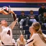 With teammates rushing the net, White River Highs Taylor Arnold sets up a play during her teams Friday nights district victory.