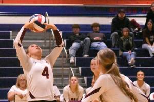 With teammates rushing the net, White River Highs Taylor Arnold sets up a play during her teams Friday nights district victory.