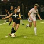 PHOTO BY KEVIN HANSON
EHS forward Sutton Kelsey races past a Prairie High defender during the Hornets November 12, home-field victory.
