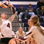 PHOTO BY KEVIN HANSON With teammates rushing the net, White River Highs Taylor Arnold sets up a play during her teams Friday nights district victory.