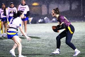 PHOTO COURTESY STEPHANIE FINDLEY 
Enumclaw High quarterback Madison Holden looks for an open receiver while avoiding a Tahoma defender during the Hornets first flag football game.