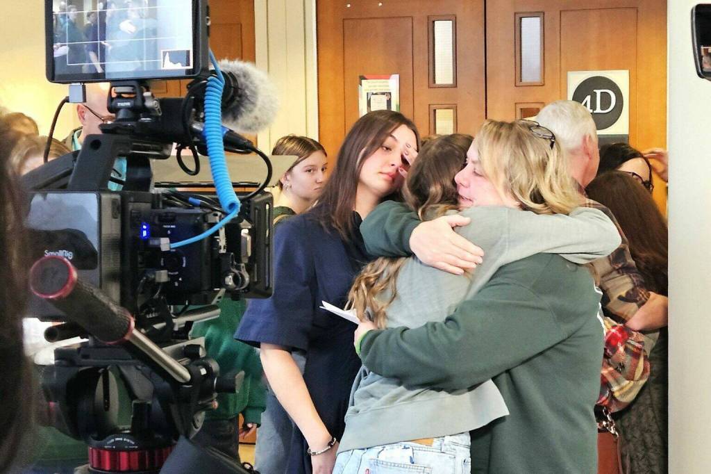 Tanie Valison and her daughters tearfully hug after the the sentence of Andrew Baim, found guilty this year of killing Nick Valison back in 2023, was given the maximum sentence of 24.5 years in prison on Dec. 18.