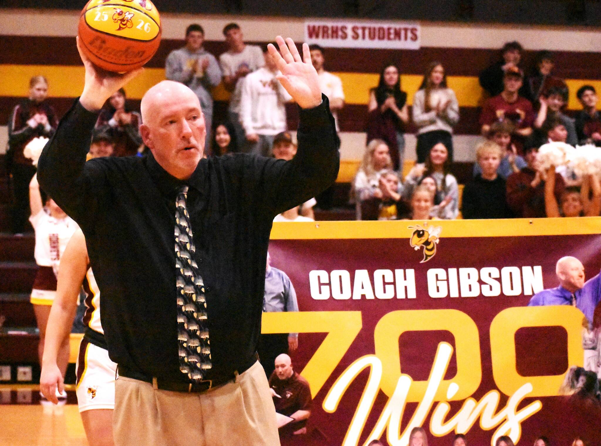 PHOTO BY KEVN HANSON 
Chris Gibson acknowledges the cheering crowd during a White River High ceremony recognizing his 700th career victory.