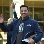Seahawks head coach Mike Macdonald waves and holds the Lombardi Trophy during the parade. Photos by Ben Ray / Sound Publishing