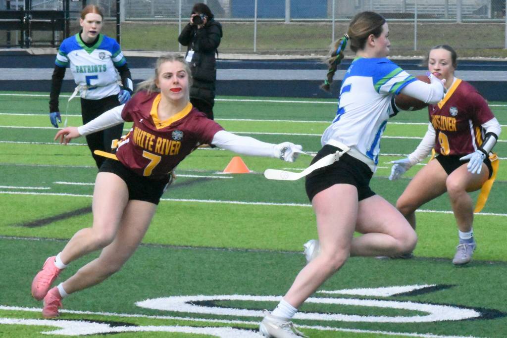 PHOTO BY KEVIN HANSON Riley Soule (#7) stretches to pull the flag of a Liberty ballcarrier during Saturdays action at Federal Way Memorial Stadium.