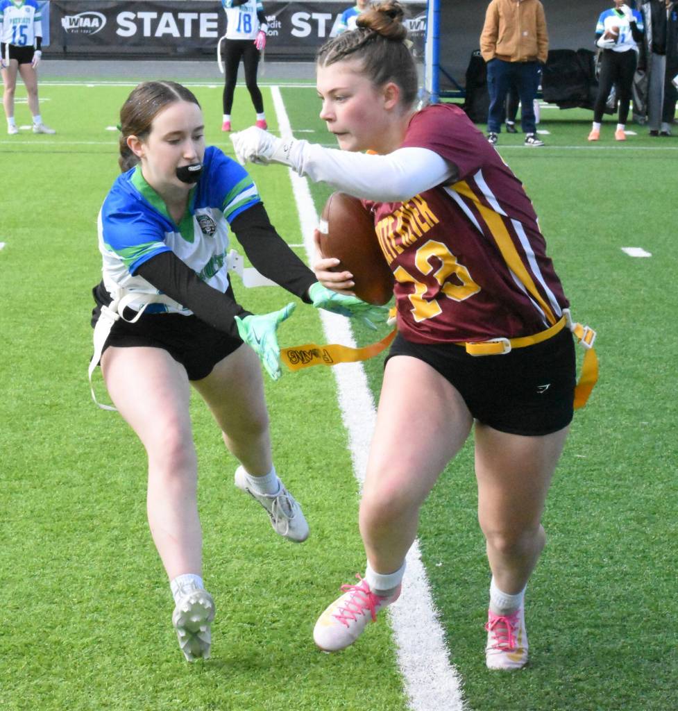 PHOTO BY KEVIN HANSON After catching a pass Saturday afternoon Hornet freshman Lolo Sproed looks for extra yardage as a Liberty player closes in.