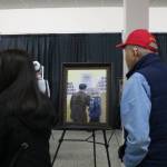 Attendees take in art by Chris Hopkins exploring the incarceration experience. Photo by Bailey Jo Josie/Sound Publishing