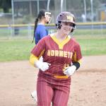 Laken Elvig gives a big smile after hitting a home run against Decatur. Ben Ray / The Mirror