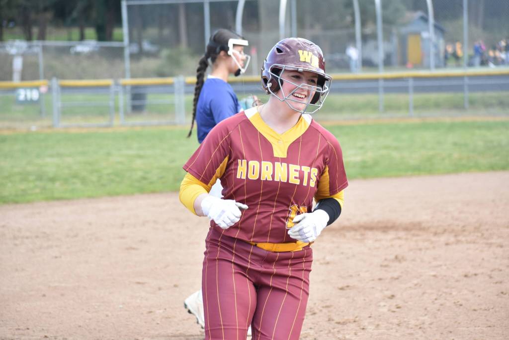 Laken Elvig gives a big smile after hitting a home run against Decatur. Ben Ray / The Mirror