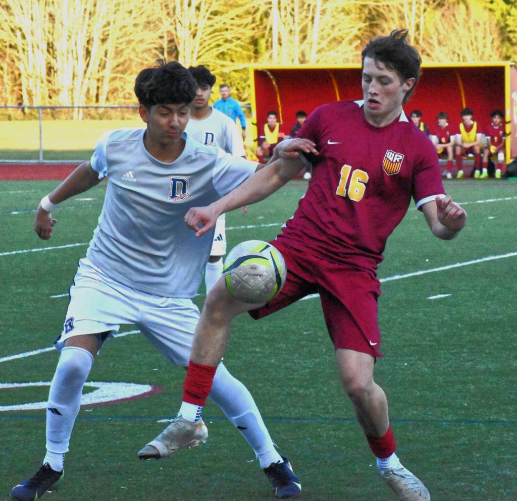 PHOTO BY KEVIN HANSON White River junior Dylan Berdan (#16) battles a Decatur defender for ball control during the early stages of Friday nights NPSL 3A game at Arrow Lumber Stadium. The visiting Gators left the Buckley campus with a 2-0 victory.