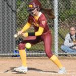 PHOTO BY KEVIN HANSON Later in the game White Rivers Charleigh Laeuger puts a ball into play and heads for first.