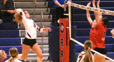 PHOTOs BY KEVIN HANSON 
With teammates rushing the net, White River Highs Taylor Arnold sets up a play during the districts tournament.