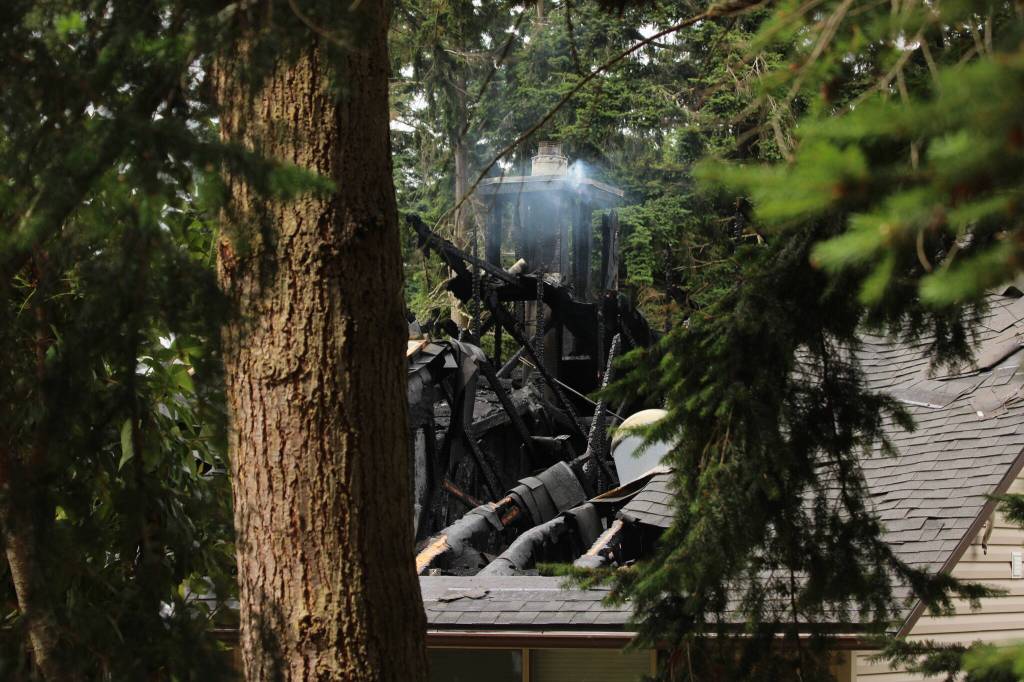 Photo by Allyson Ballard. A portion of a neighboring home still smoldered on Thursday.