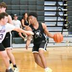 Auburns Emanuel Rogers dribbles the basketball with a defender on him. Ben Ray / The Reporter