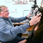 Dr. Mark Seaburb giving an exam to Taylor Maloney, a new patient and employee. Photo by Ray Miller-Still