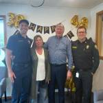 Firefighters and police officers stopped by the Enumclaw Vision Clinic to pay their respects to the retiree. Also pictured is Robin Grennan, who has worked with Seaburg for 38 years. Contributed photo