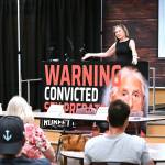 Cathy Dahlquist, co-founder of Save Our Children - Enumclaw and host of the nights meeting, gestured to places set for the King County Sheriffs Department, the Pierce County Prosecutor, and the Department of Corrections; all were invited to come meet the community in-person, but only KCSO responded, but conducted a virtual meeting instead. Photo by Ray Miller-Still
